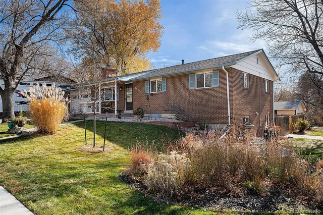 a view of a house with pool and chairs