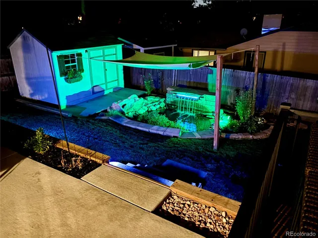 a view of a chairs and table in the backyard