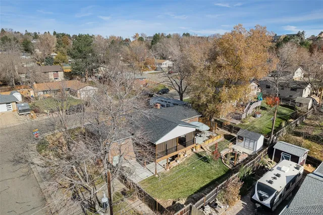 an aerial view of multiple houses with a yard