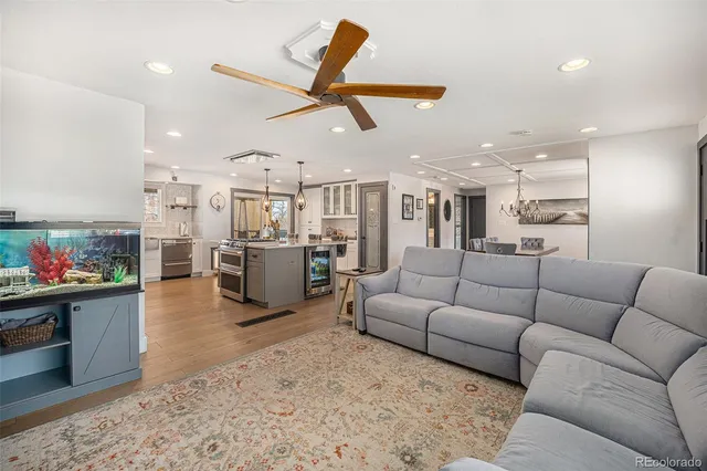 a living room with furniture and kitchen view