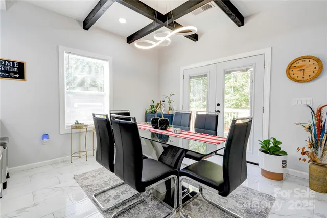 a dining room with furniture window and wooden floor