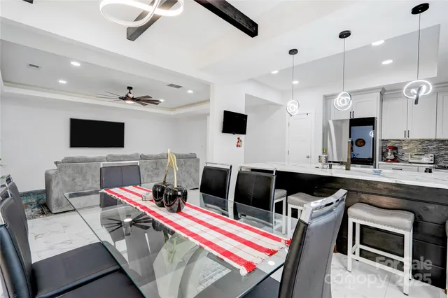 a view of kitchen and living room with wooden floor