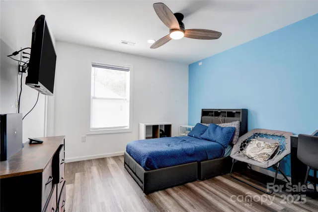 a bedroom with furniture and a window