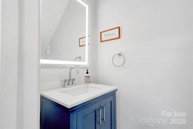 a bathroom with a sink vanity and a mirror