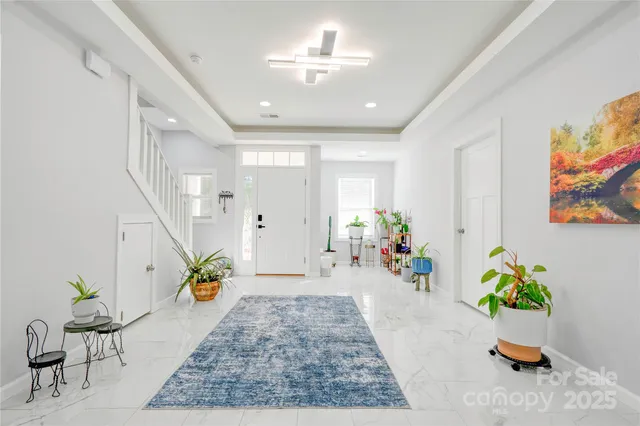 a living room filled with furniture and a chandelier