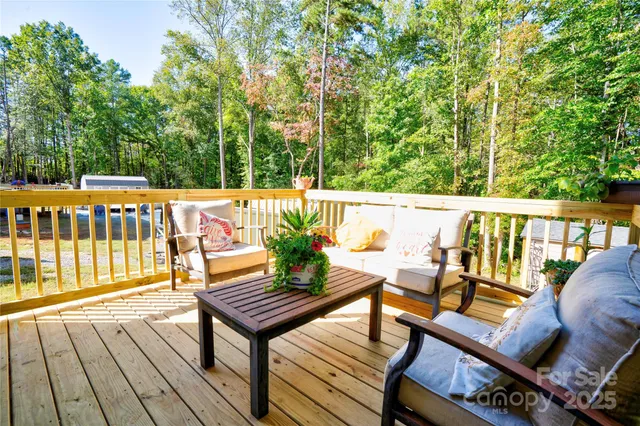 a view of a chairs and table on the wooden deck