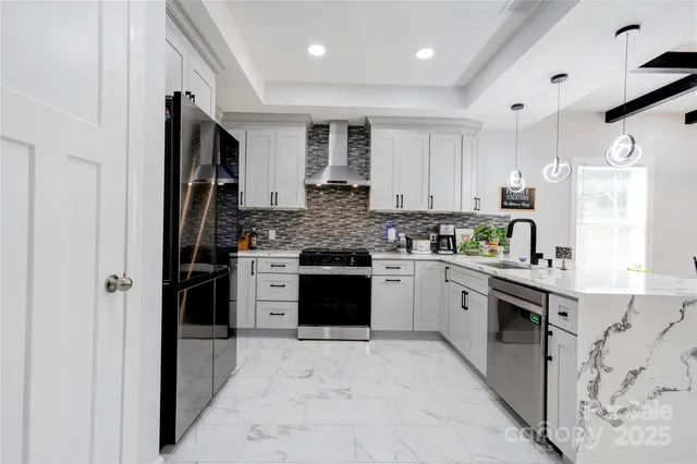 a kitchen with stainless steel appliances granite countertop a refrigerator sink and cabinets