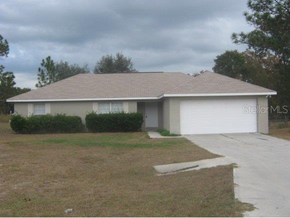 a view of a house with a yard and garage