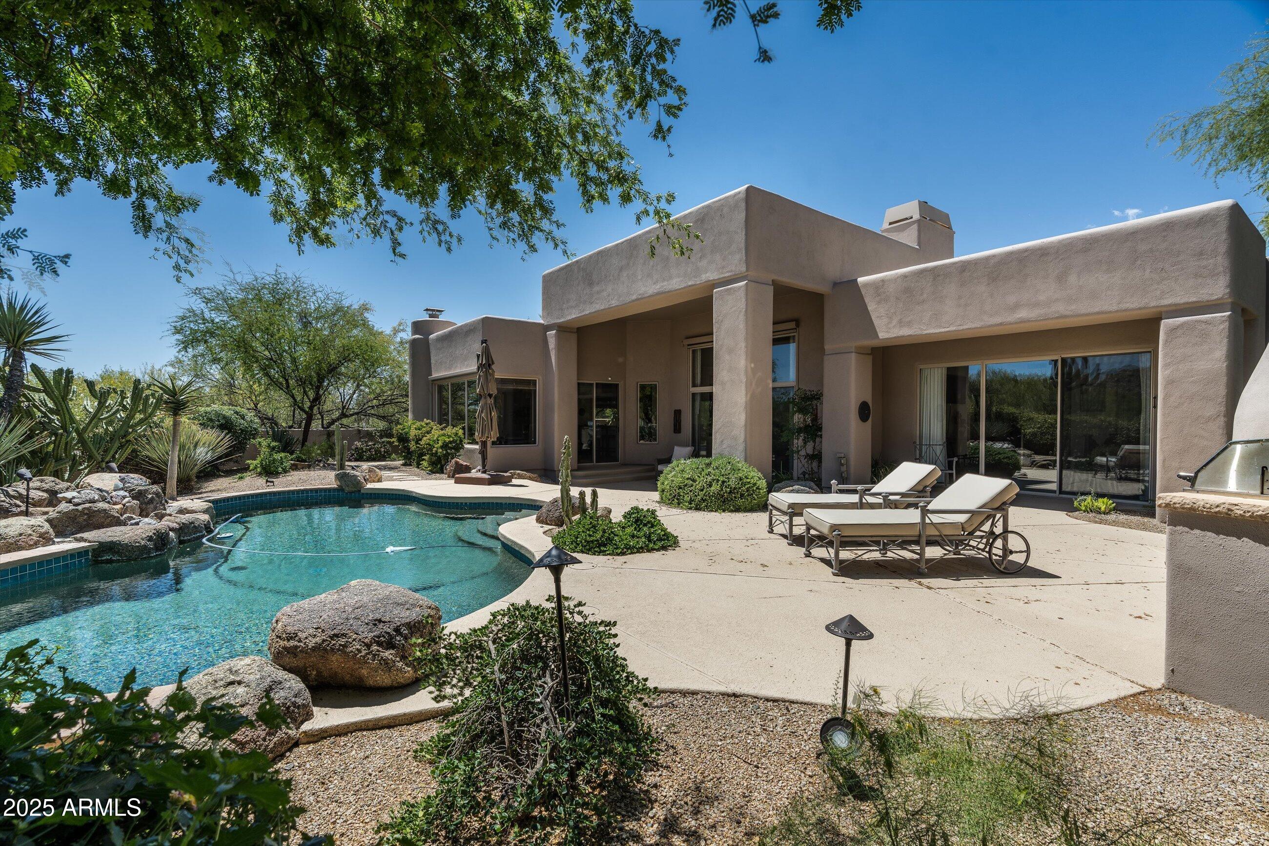 34221 North Boulders Parkway Scottsdale, AZ 85266 - Photo 1 of 31 a view of a house with pool and sitting area