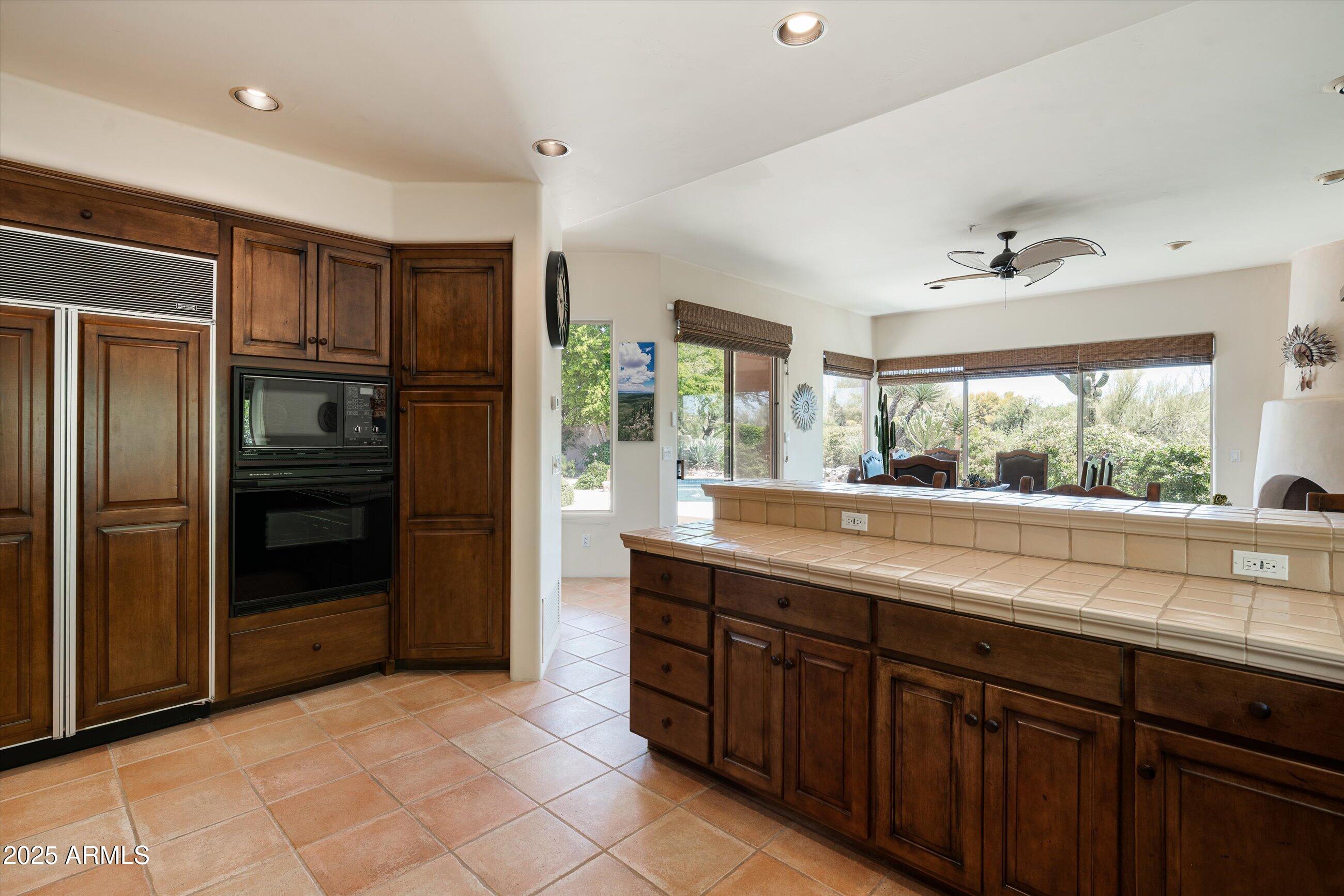 34221 North Boulders Parkway Scottsdale, AZ 85266 - Photo 11 of 31 a kitchen with stainless steel appliances granite countertop a refrigerator and a sink