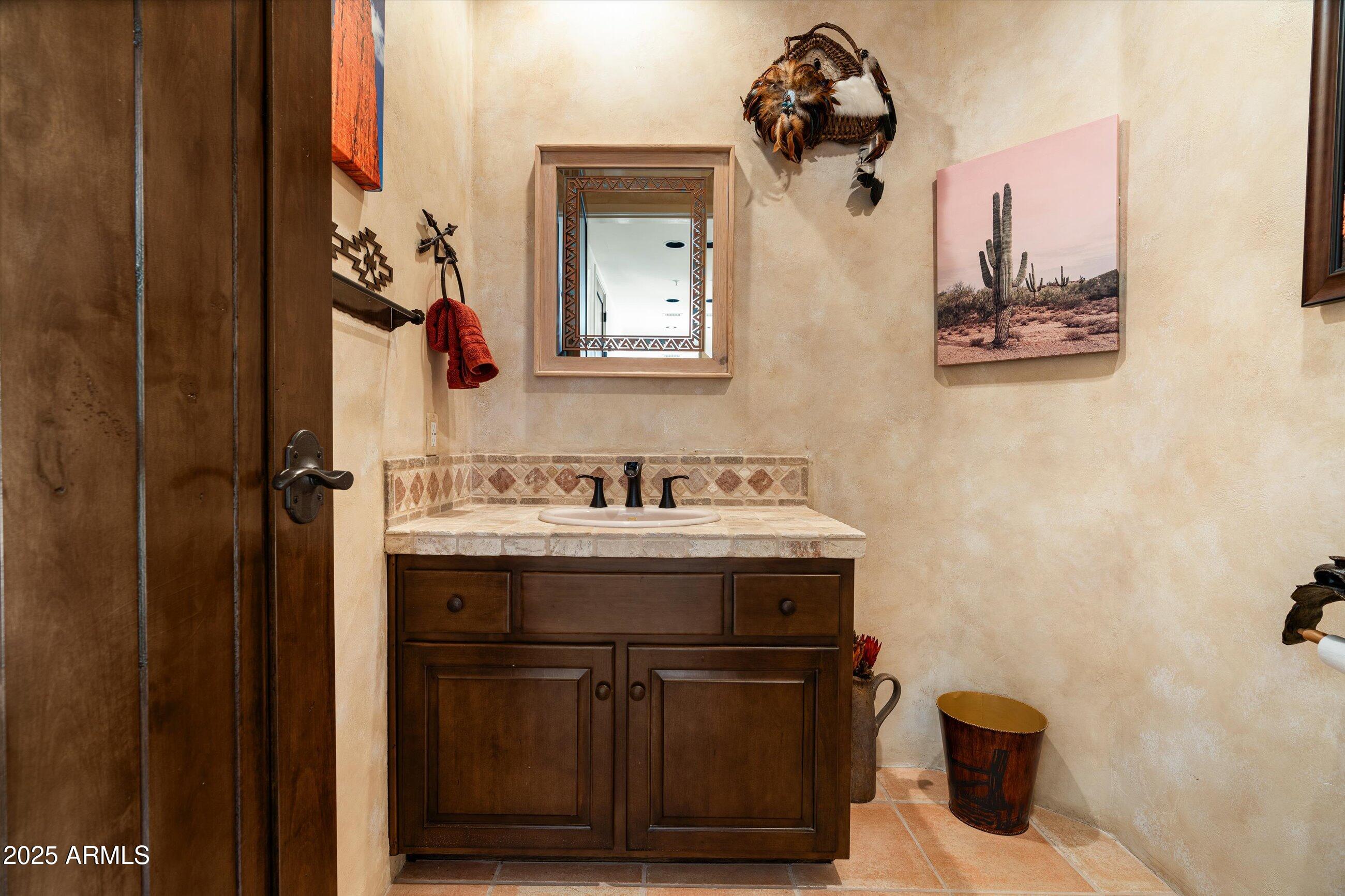 34221 North Boulders Parkway Scottsdale, AZ 85266 - Photo 14 of 31 a bathroom with a sink a mirror and a toilet