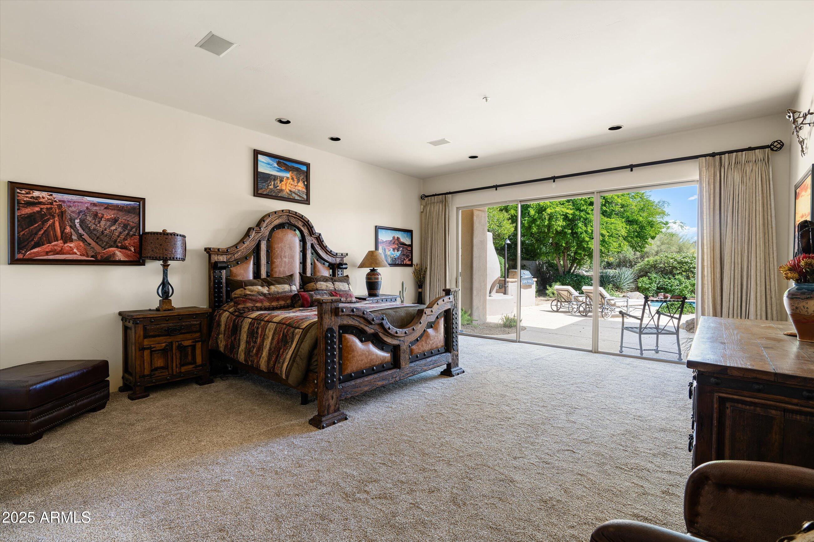 34221 North Boulders Parkway Scottsdale, AZ 85266 - Photo 16 of 31 a spacious bedroom with a bed and a large window