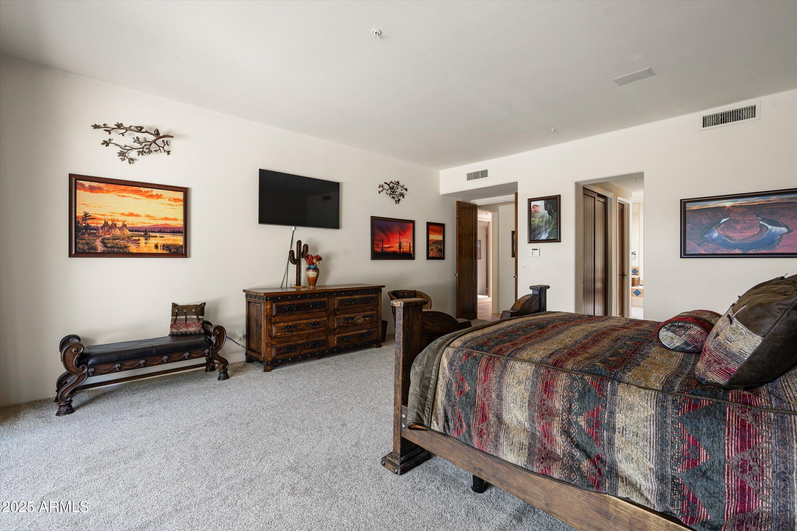 34221 North Boulders Parkway Scottsdale, AZ 85266 - Photo 18 of 31 a bedroom with a bed and a flat screen tv