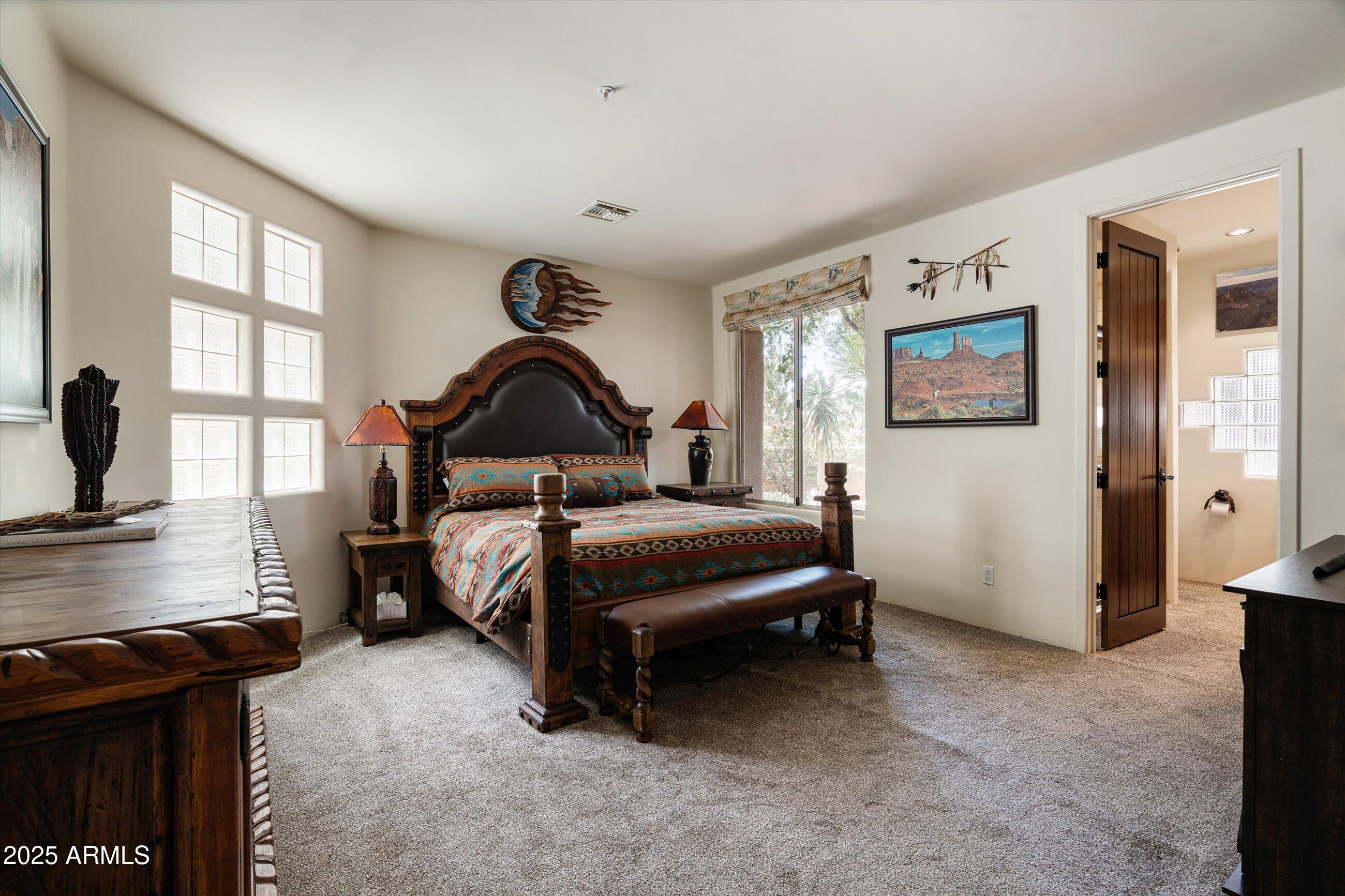 34221 North Boulders Parkway Scottsdale, AZ 85266 - Photo 23 of 31 a bedroom with a bed and dresser with window