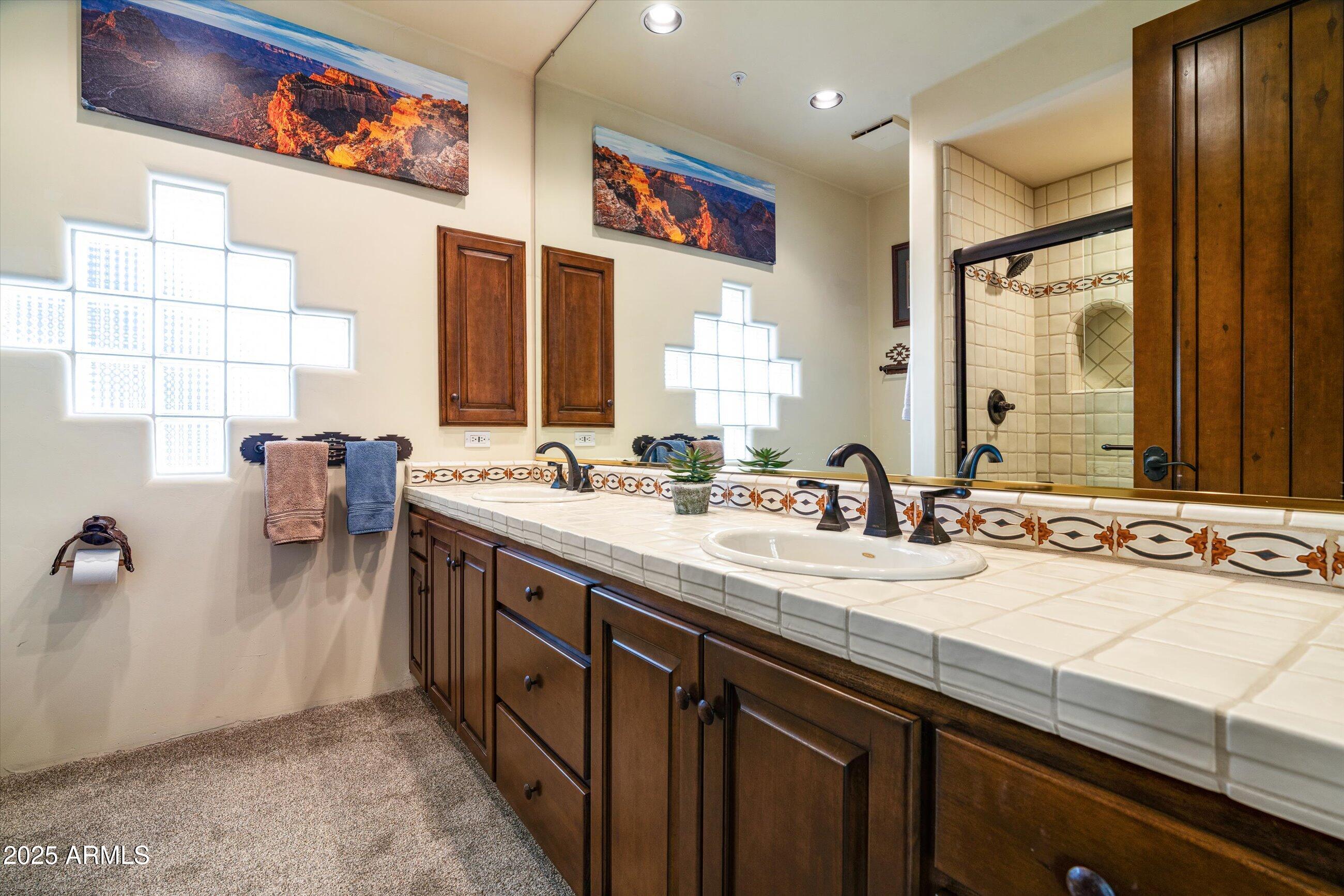 34221 North Boulders Parkway Scottsdale, AZ 85266 - Photo 24 of 31 a spacious bathroom with a double vanity sink and a mirror