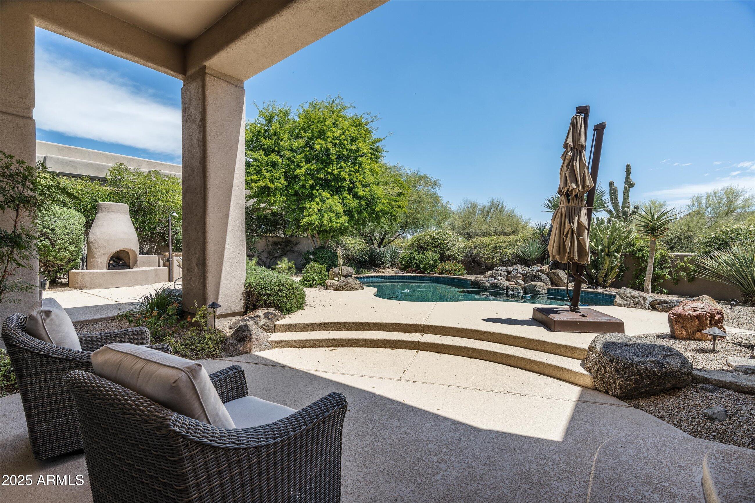 34221 North Boulders Parkway Scottsdale, AZ 85266 - Photo 26 of 31 a view of swimming pool with outdoor seating and plants