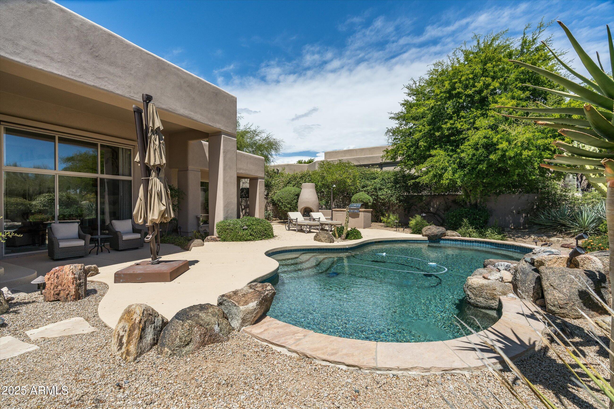 34221 North Boulders Parkway Scottsdale, AZ 85266 - Photo 27 of 31 a swimming pool with outdoor seating and yard