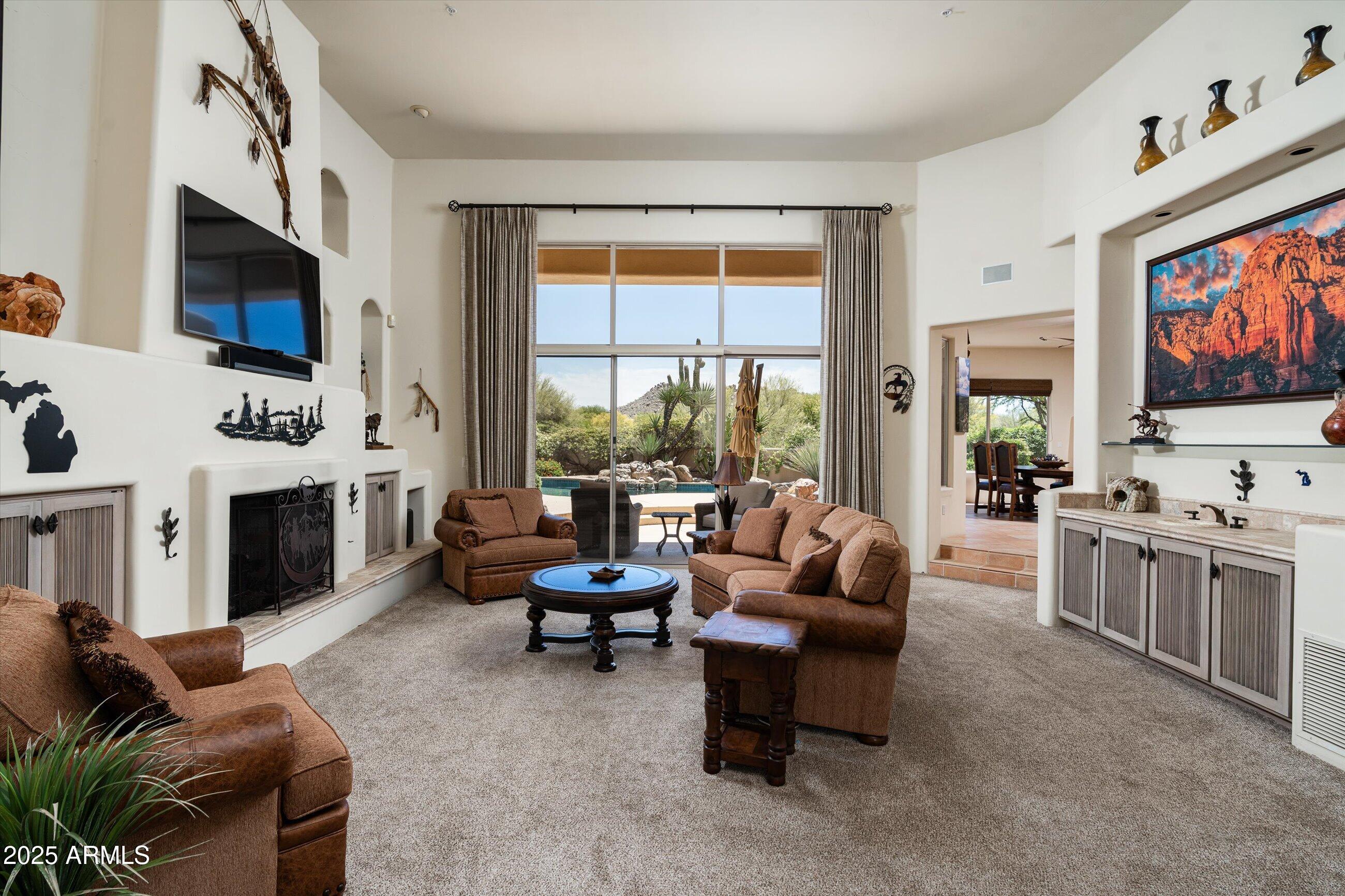 34221 North Boulders Parkway Scottsdale, AZ 85266 - Photo 6 of 31 a living room with furniture flat screen tv and a fireplace