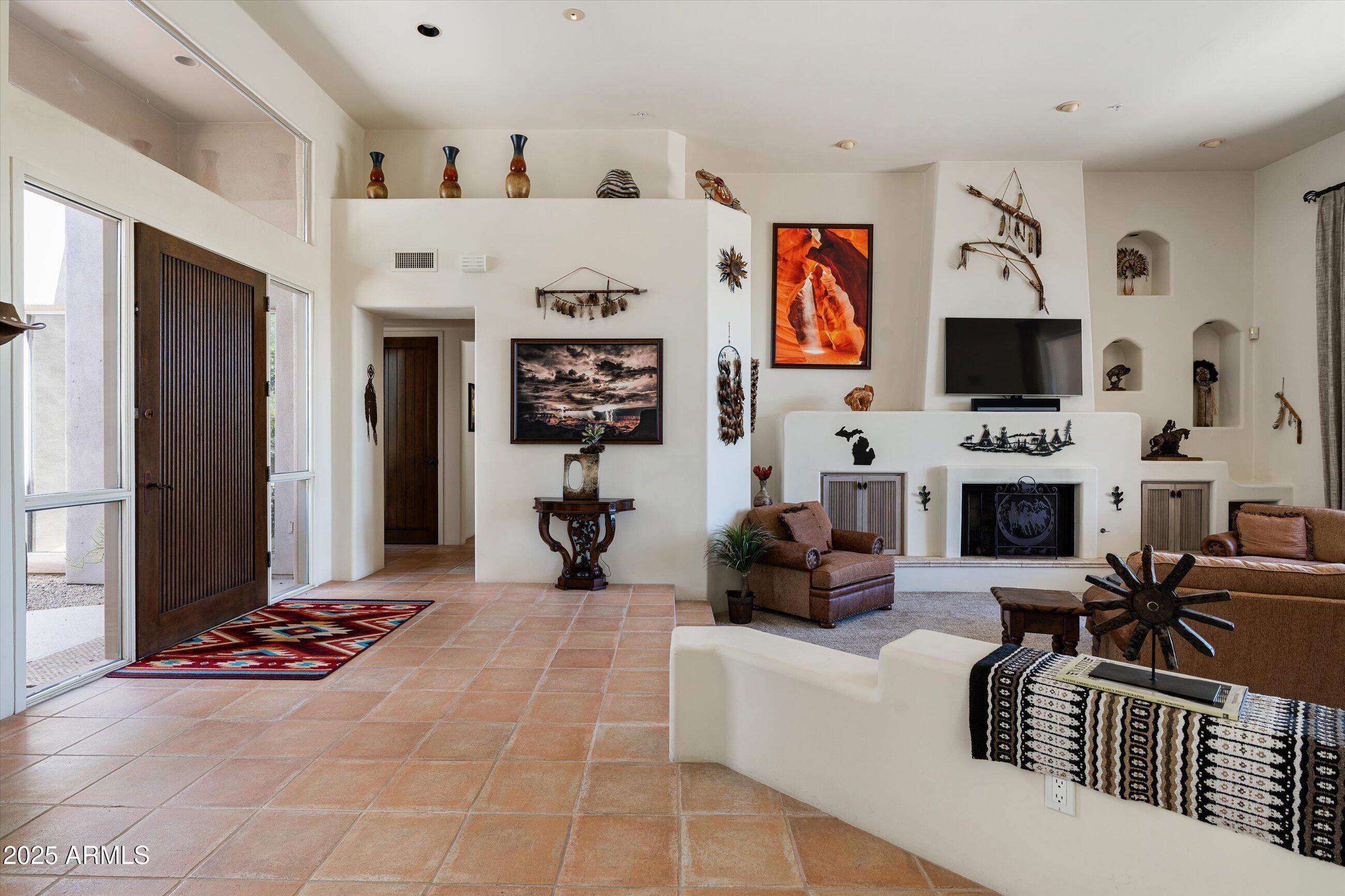 34221 North Boulders Parkway Scottsdale, AZ 85266 - Photo 8 of 31 a living room with furniture a flat screen tv and a fireplace
