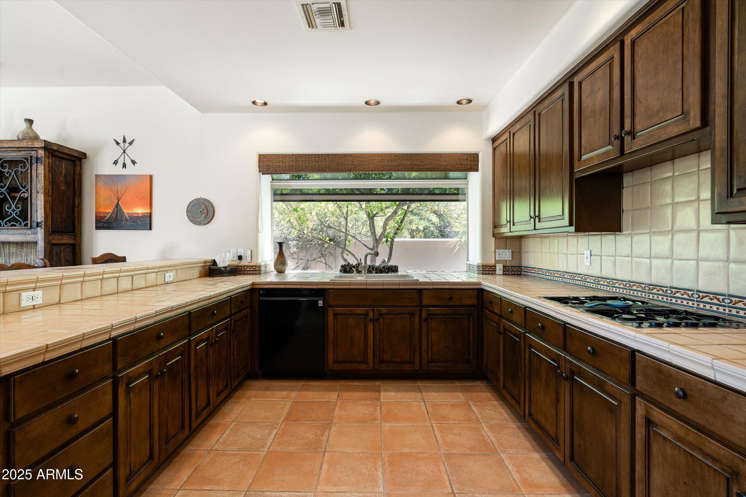 34221 North Boulders Parkway Scottsdale, AZ 85266 - Photo 10 of 31 a kitchen with stainless steel appliances granite countertop a sink stove and cabinets