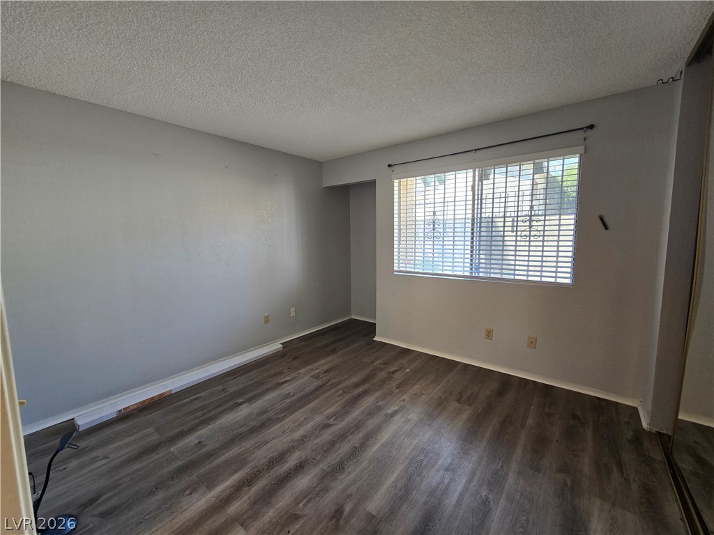 6750 Del Rey Avenue, Unit 133 Las Vegas, NV 89146 - Photo 15 of 34 Well-lit living area with durable plank flooring, ready for your personalized touch.
