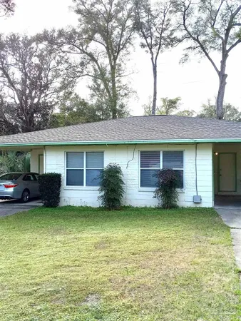 a view of a house with a swimming pool and a yard
