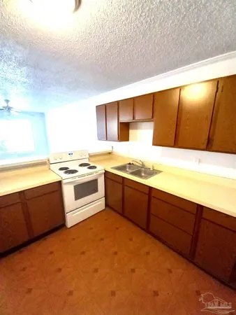 a kitchen with stainless steel appliances granite countertop a stove and a sink