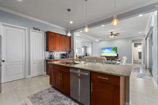 a kitchen with sink stove and refrigerator