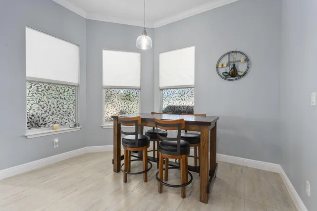 a dining room with wooden floor and a window