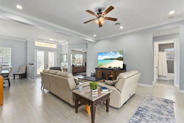 a living room with furniture a rug and a chandelier