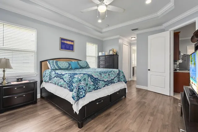 a bedroom with a bed and a chandelier