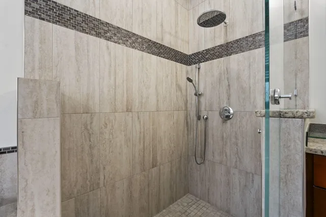 a bathroom with a tub sink and mirror