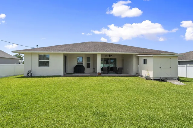 a view of an house with backyard space and balcony