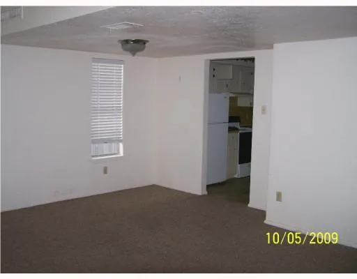 an empty room with windows and closet