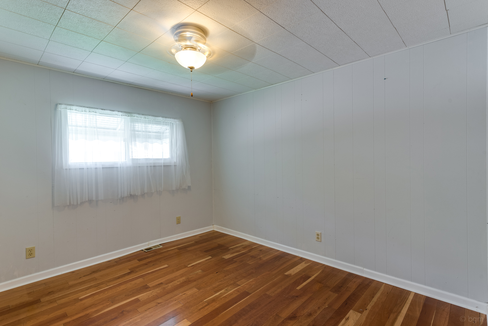 1110 Lakewood Road Elgin, IL 60123 - Photo 16 of 24 an empty room with wooden floor and windows