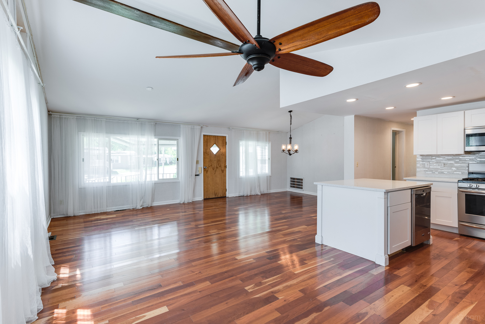 1110 Lakewood Road Elgin, IL 60123 - Photo 3 of 24 a view of empty room with wooden floor and fan