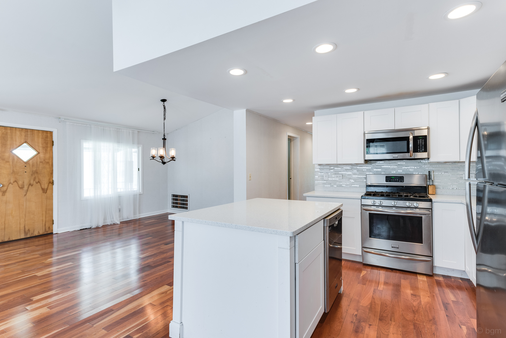 1110 Lakewood Road Elgin, IL 60123 - Photo 5 of 24 a kitchen with stainless steel appliances kitchen island granite countertop a stove a sink a refrigerator and a microwave
