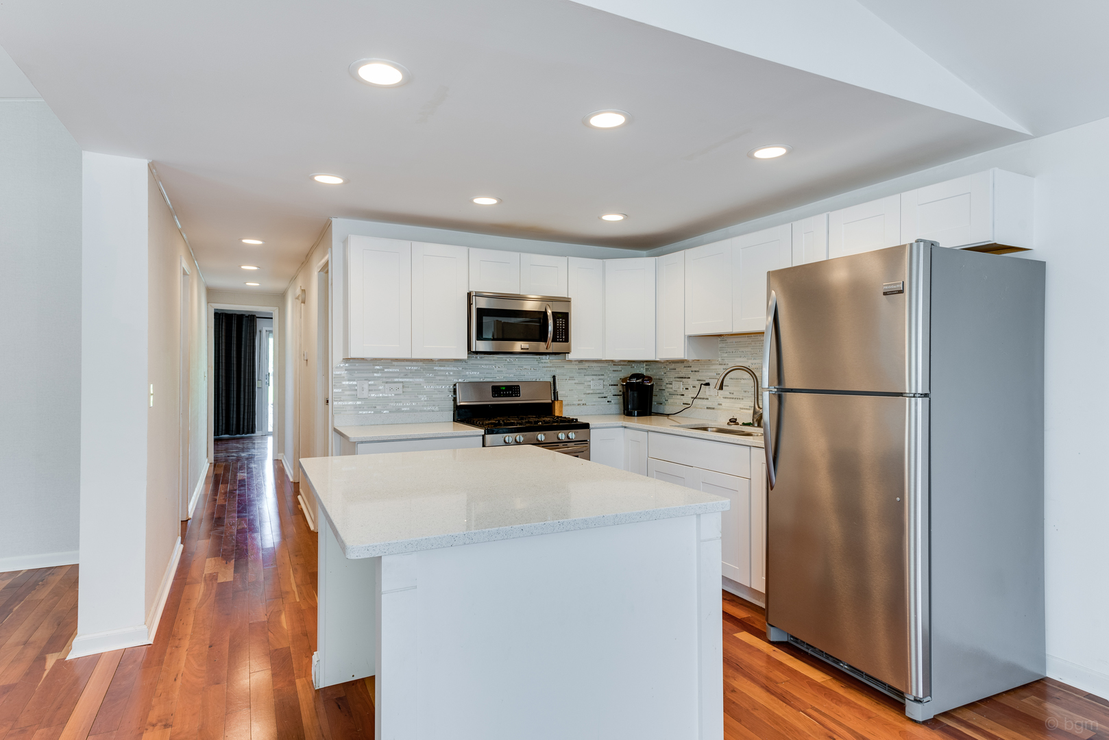 1110 Lakewood Road Elgin, IL 60123 - Photo 8 of 24 a kitchen with refrigerator a microwave and cabinets
