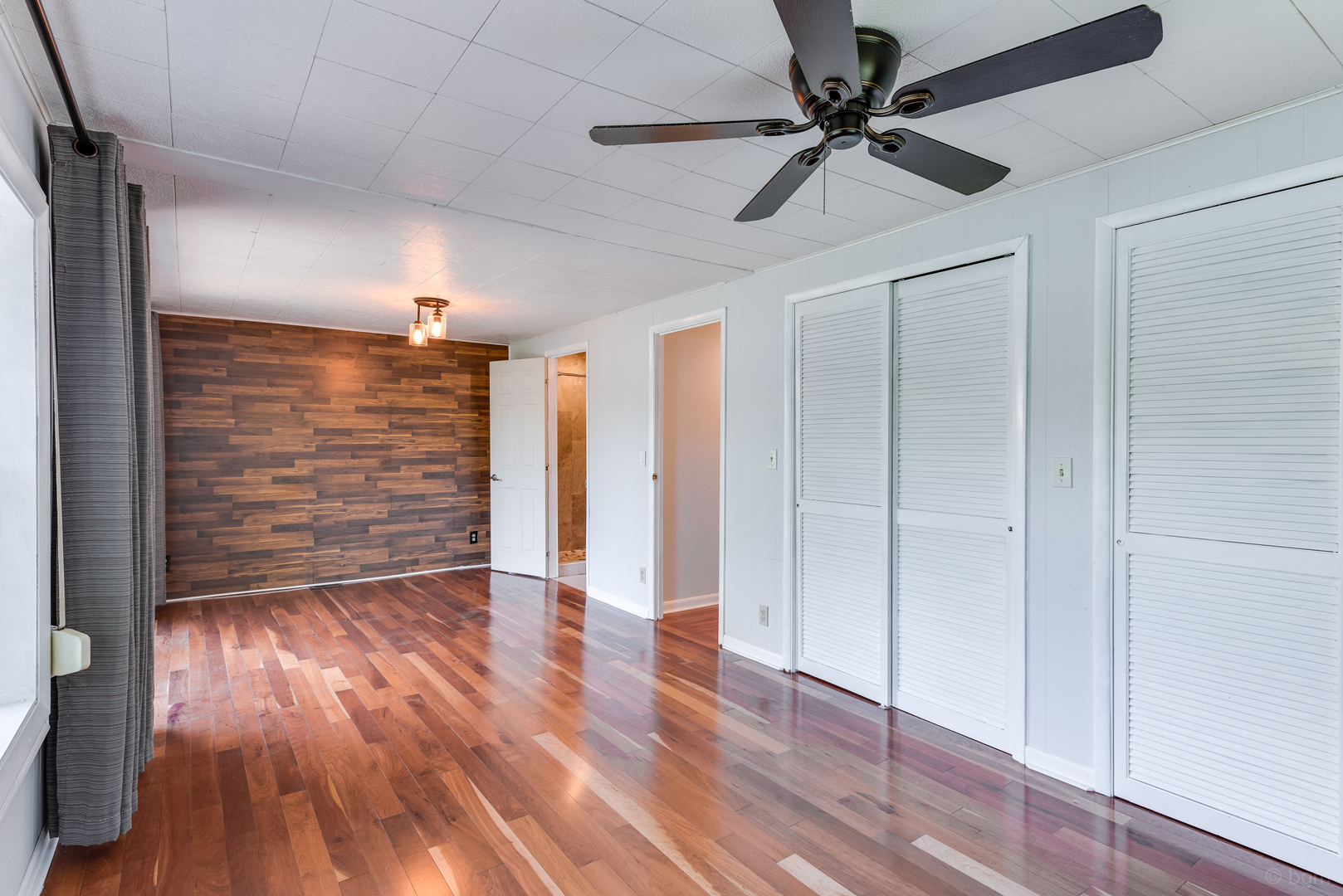 1110 Lakewood Road Elgin, IL 60123 - Photo 10 of 24 a view of an empty room with a window and wooden floor