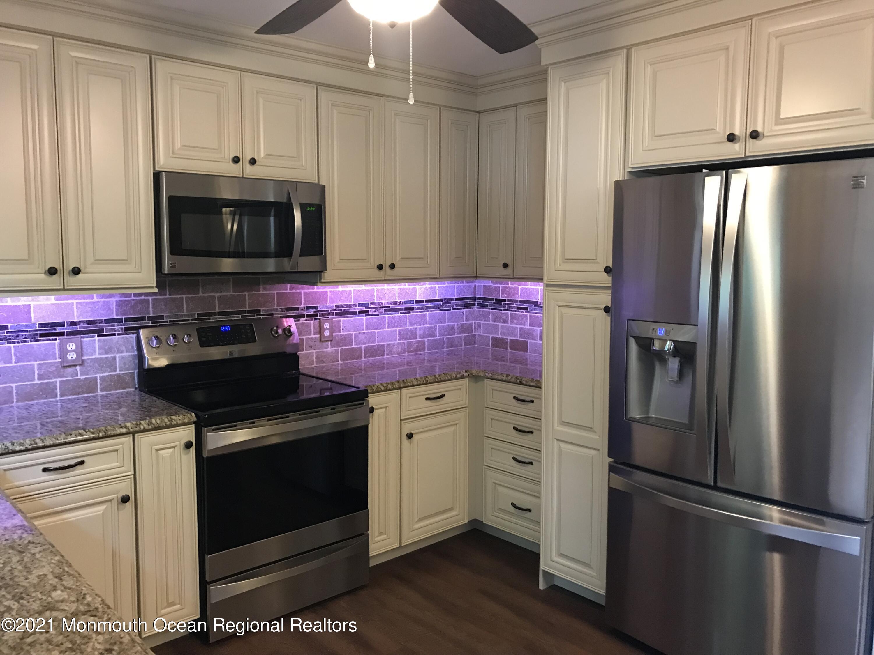 21 Kuzyk Road Cream Ridge, NJ 08514 - Photo 20 of 45 a kitchen with stainless steel appliances granite countertop a refrigerator stove and microwave