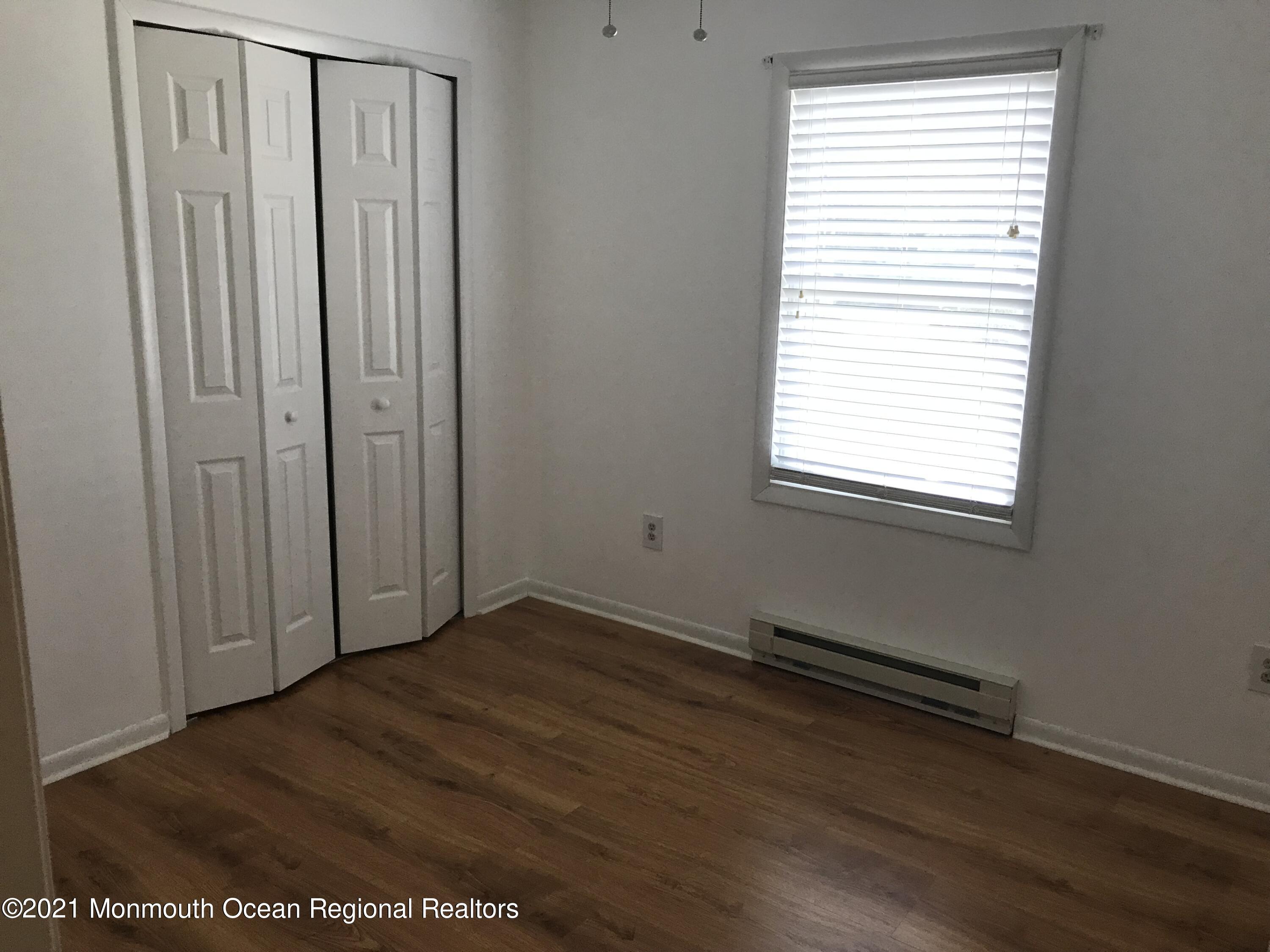 21 Kuzyk Road Cream Ridge, NJ 08514 - Photo 29 of 45 an empty room with wooden floor and windows