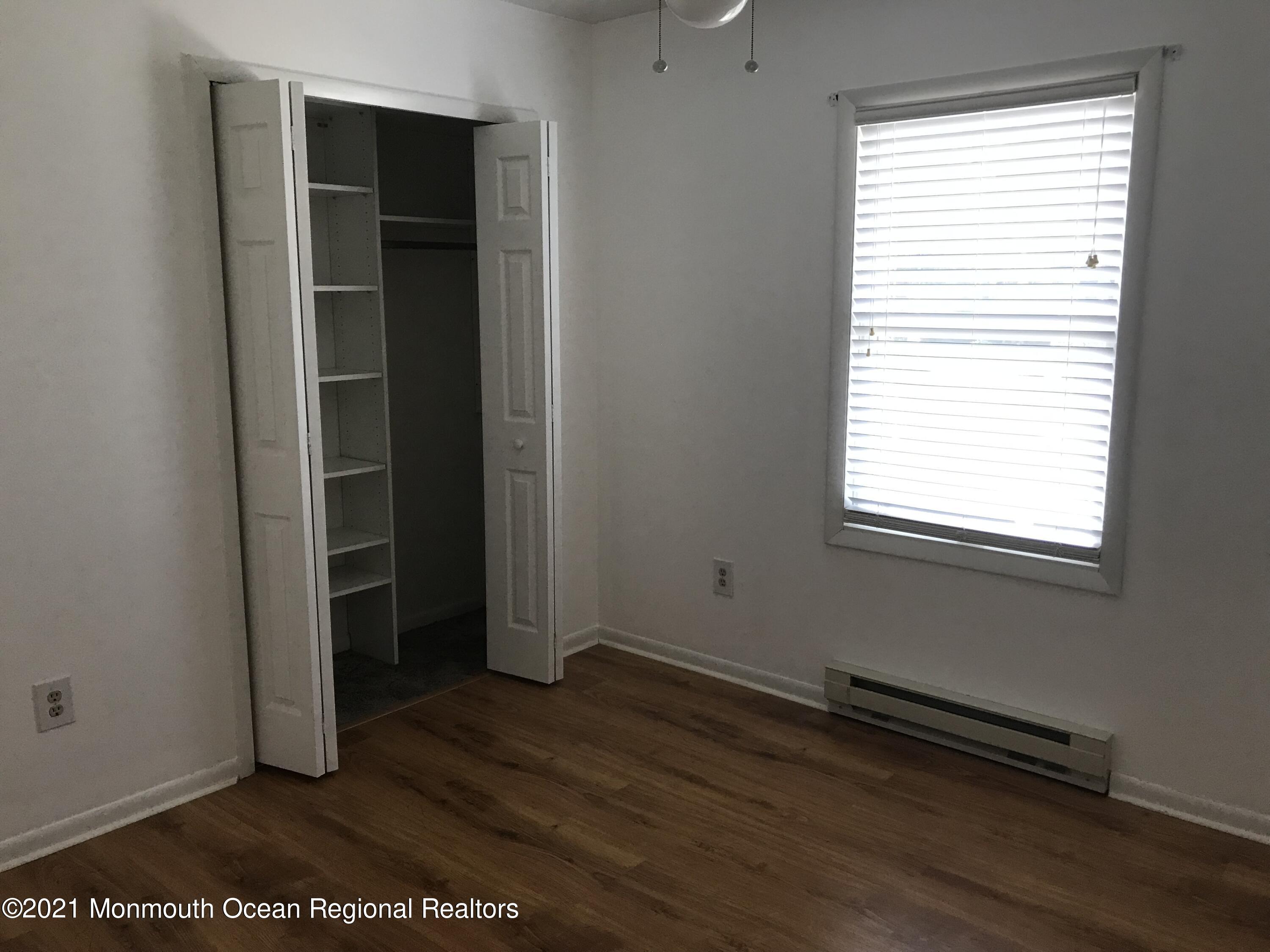 21 Kuzyk Road Cream Ridge, NJ 08514 - Photo 30 of 45 an empty room with wooden floor and windows