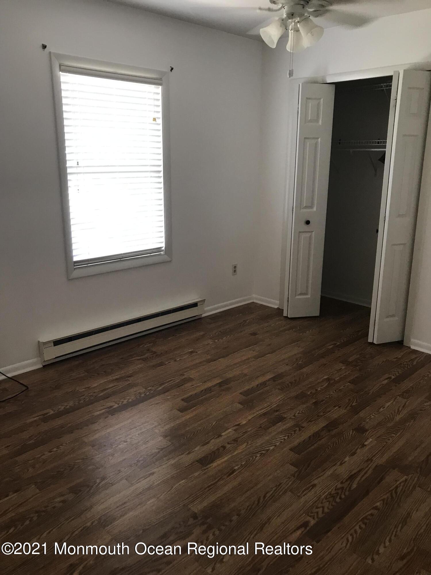 21 Kuzyk Road Cream Ridge, NJ 08514 - Photo 31 of 45 an empty room with wooden floor and windows