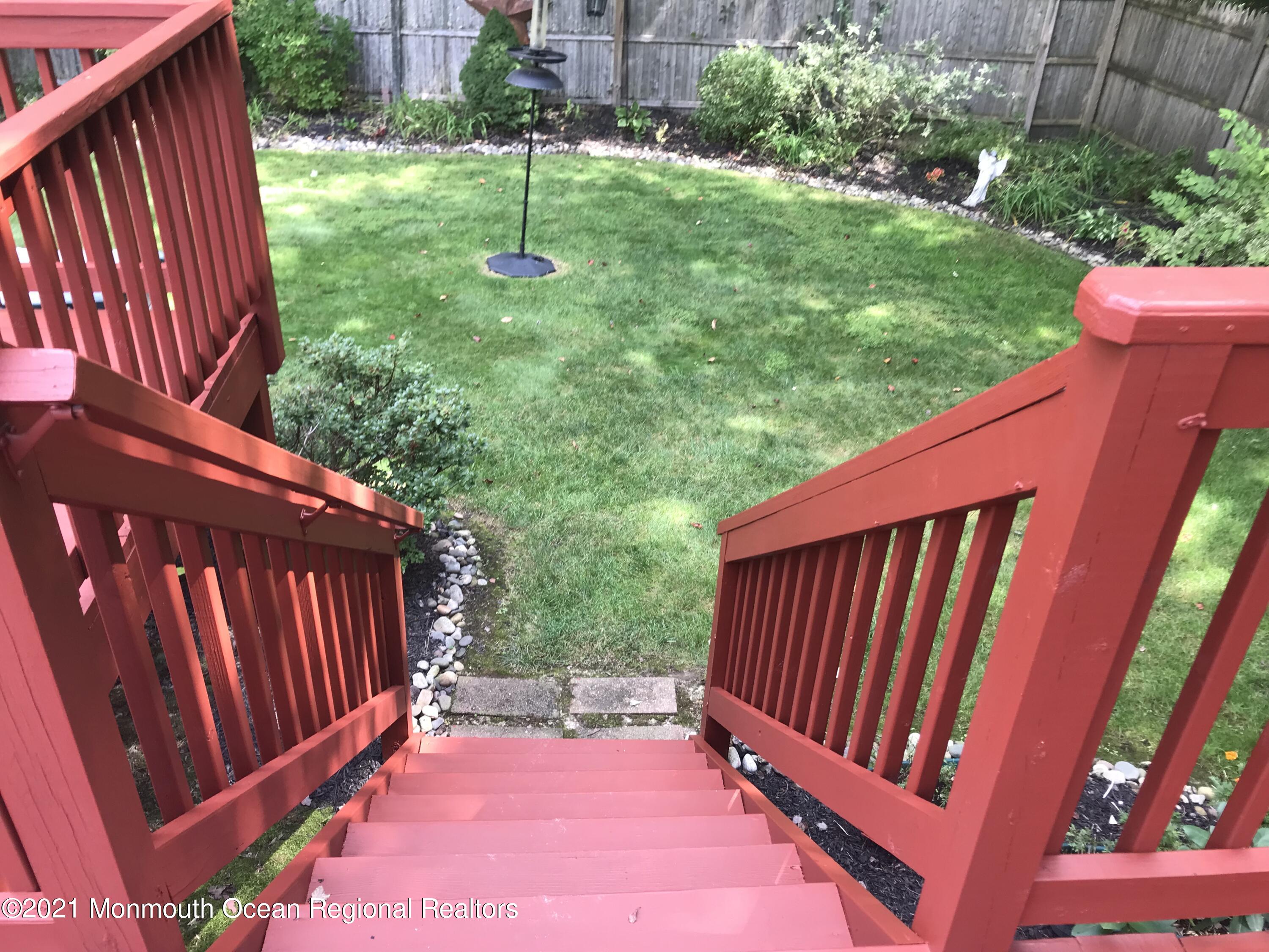 21 Kuzyk Road Cream Ridge, NJ 08514 - Photo 7 of 45 a view of a backyard with a swing table and chairs