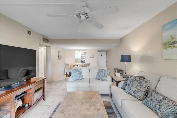 a living room with furniture and a floor to ceiling window