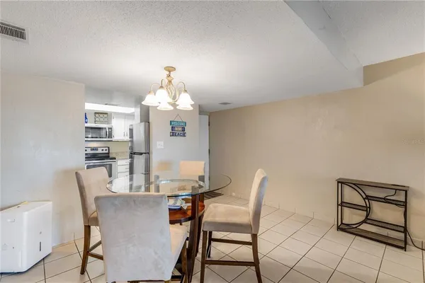 a view of a dining room with furniture and chandelier