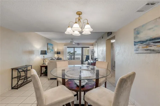 a kitchen with granite countertop white cabinets and stainless steel appliances