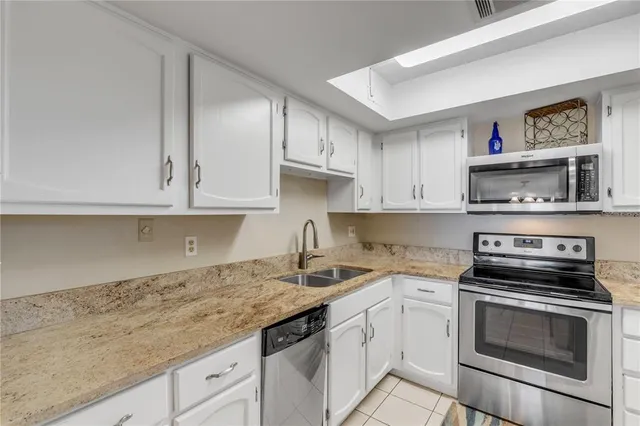 a kitchen with stainless steel appliances granite countertop a sink and cabinets