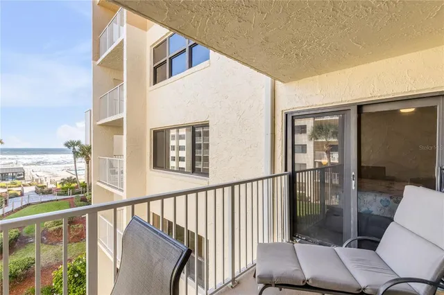 a large bedroom with a large bed and a large window with the outer view