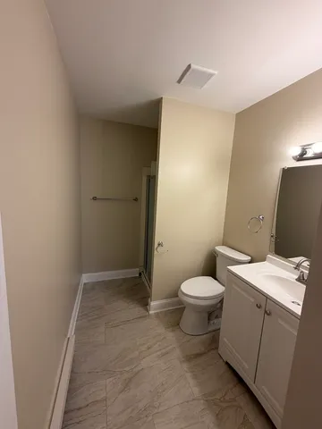 a bathroom with a glass shower door